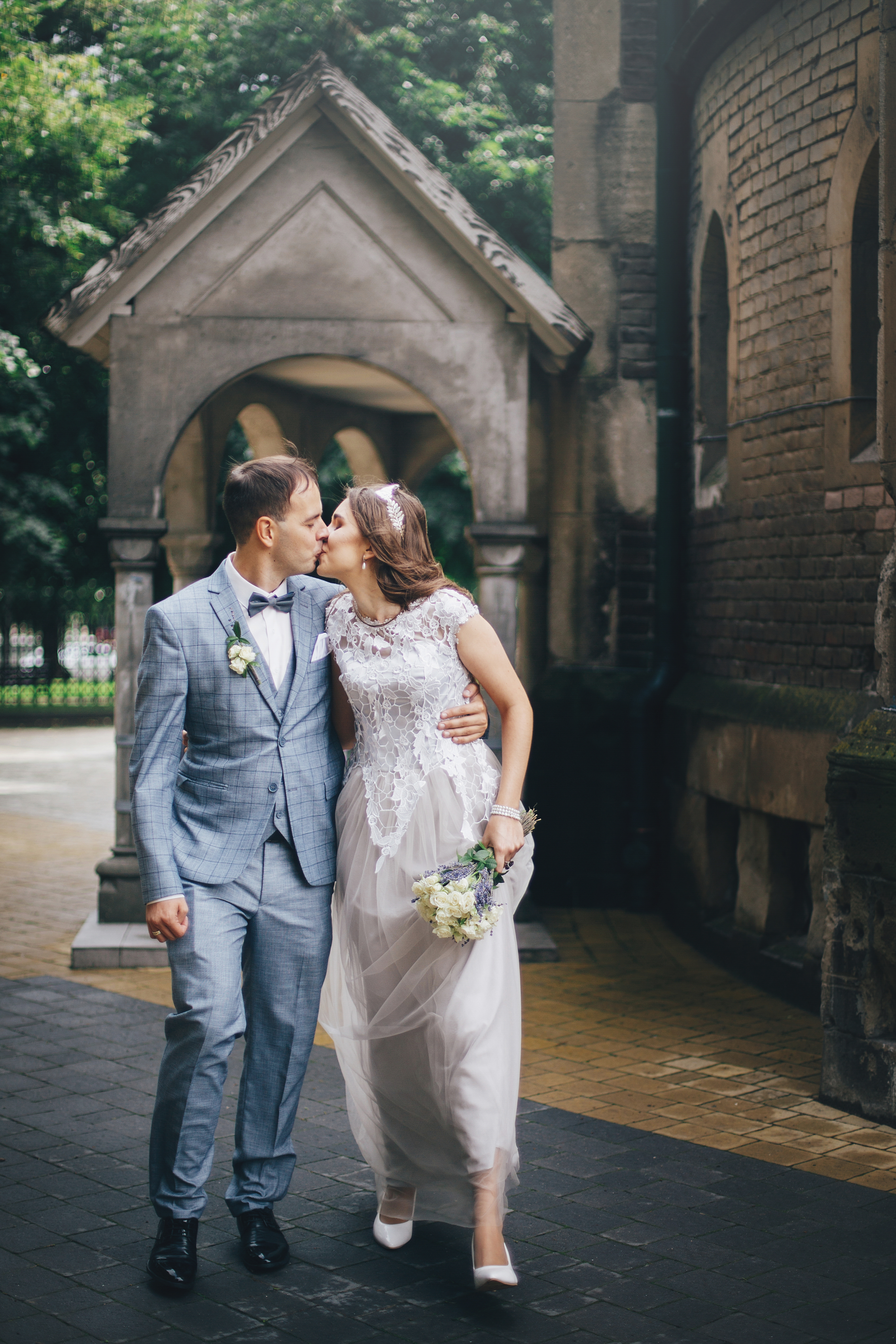 Beautiful emotional wedding couple kissing and walking in european city. Provence wedding